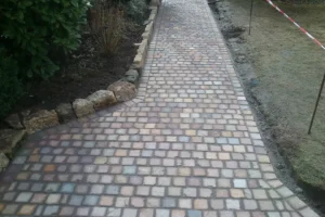 Hochwertig angelegte Pflasterwege als funktionale Elemente im Garten.